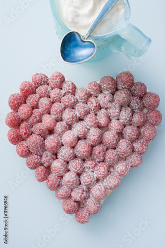 Photo: raspberry tart with icing sugar, whipped cream in small jug raspberry tart with icing sugar, whipped cream in small jug