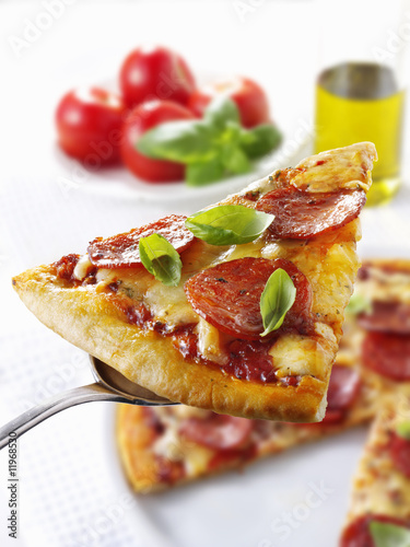 Photo: slice of pepperoni pizza on server slice of pepperoni pizza on server