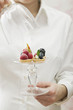 woman serving assorted berry tarts