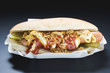 hot dog with gherkins, fried onions, mustard and ketchup
