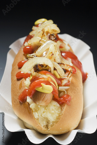 Photo: hot dog with sauerkraut, mustard, ketchup and onions hot dog with sauerkraut, mustard, ketchup and onions