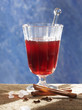 a glass of jagertee with sugar crystals, cinnamon & cloves