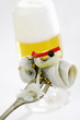 a rollmop speared on a fork with beer in the background