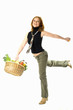 young woman holding shopping basket full of fresh food