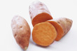 two sweet potatoes, one partly sliced