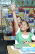 Three pupils with raised hands