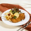 wiener schnitzel with chips, ketchup and salad