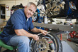 Foto: Mechanic Working on a Tire Mechanic Working on a Tire