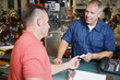 Customer in Motorcycle Shop Paying