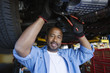 Auto Mechanic Beneath a Car