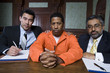 Lawyers with criminal in court
