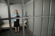 Female criminal behind bars in jail