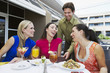 Waiter Bringing Check to Women in Restaurant