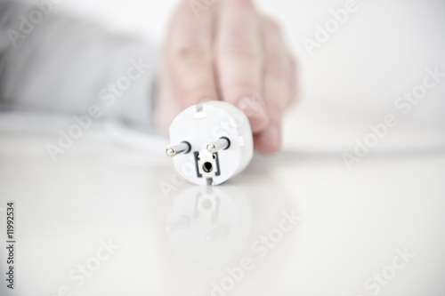 Foto: hand von mann zieht stromstecker hand von mann zieht stromstecker