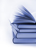 pile of books with one book open