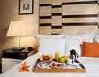 Tray with breakfast on a bed in a hotel room