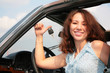 Woman in car shows a key