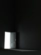 bright light from the unclosed door in a dark room