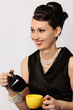 Smiling Stylish Lady in Classic Outfit Serving Coffee or Tea Smiling Stylish Lady in Classic Outfit Serving Coffee or Tea