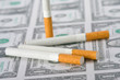 cigarettes laying on money