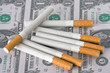 cigarettes laying on money