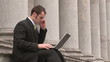Video: Footage of a Business man Outdoors Using Laptop and phone Footage of a Business man Outdoors Using Laptop and phone