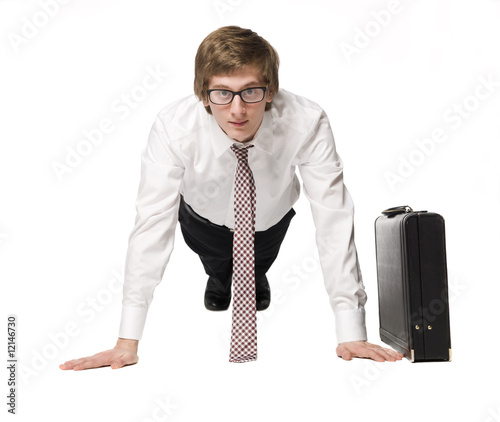 Buisnessman doing push-up's in a suit