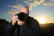 Nature photographer taking photo at sunset