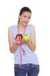 young woman holding two apples and measuring tape