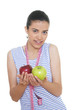 young woman holding two apples and measuring tape