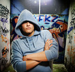 Cool looking hooligan in a graffiti painted gateway Cool looking hooligan in a graffiti painted gateway