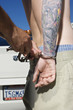 Officer Handcuffing Tattooed Young Man