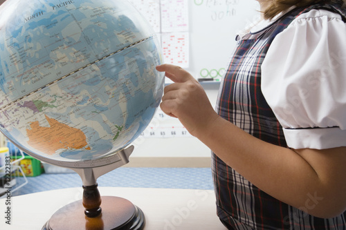 Photo: Little Girl Pointing to Globe Little Girl Pointing to Globe