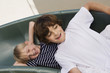 Little Boys Sliding down a Slide