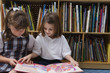 Little Girls Looking at a Picture Book