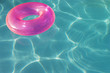 Pink Float Tube Floating in Swimming Pool