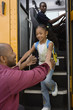 Father Picking Daughter Up at Bus Stop