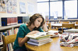 High School Student Reading in Library