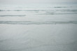 Dubai, UAE, Tiny ripples in Arabian Gulf at sunset on public beach in Jumeirah