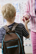 Little Boy Handing Teacher an Apple