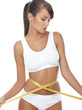 Young beautiful woman with measure tape on white