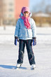 Girl on skates at the skating rink in winter