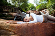 young woman relaxing by the waterfall