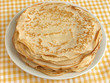 pancakes pile on yellow tablecloth pancakes pile on yellow tablecloth