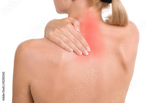 Photo: Woman holds a hand on pain neck Woman holds a hand on pain neck