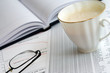 Financial balance and cup of coffee.
