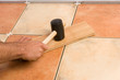 Hammering the floor tiles in place Hammering the floor tiles in place