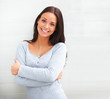 Beautiful woman standing against wall in background