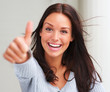 Portrait of attractive young female showing a thumbs up