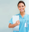 Beautiful gorgeous nurse holding writingpad and smiling